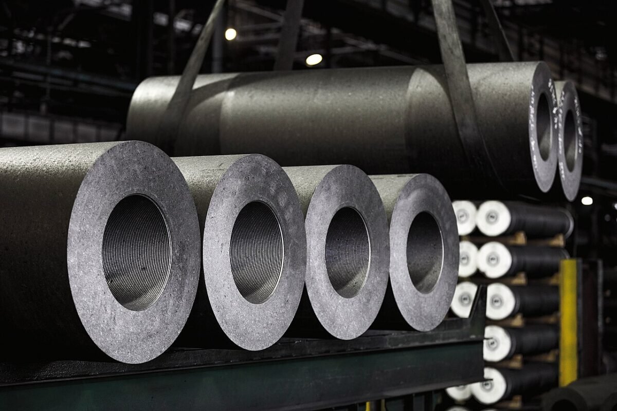 Rows of full-size graphite electrodes with accurately machined threaded sockets in an electrode plant