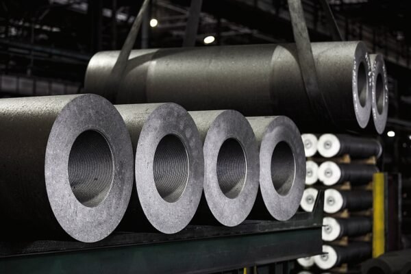 Rows of full-size graphite electrodes with accurately machined threaded sockets in an electrode plant